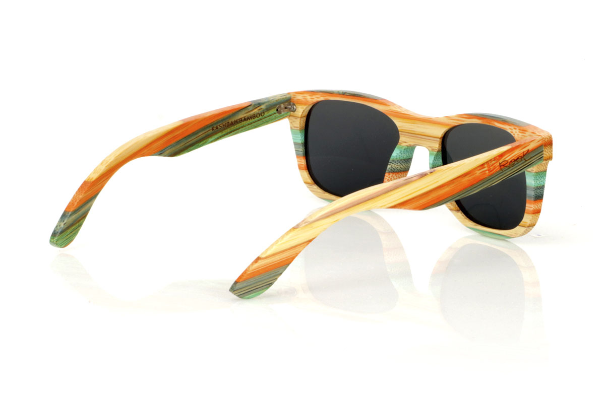 Wood eyewear of Bamboo KASHBAH. KASHBAH sunglasses, with a classic design and a slightly smaller size than the standard, make the difference in our bamboo collection. These glasses are made of vertically laminated bamboo wood, creating a pattern of soft colors that capture the light and the gaze of whoever sees them. The colorful result is not only visually attractive, but also adds a touch of originality and freshness to your style. With measurements of 143x46 and a caliber of 52, the KASHBAH are perfect for those looking for comfortable, light glasses with a unique touch that will not go unnoticed. for Wholesale & Retail | Root Sunglasses® 